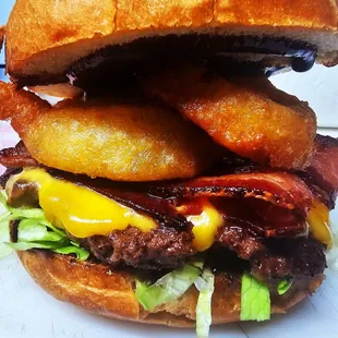 Boy howdy burger  Smoke BBQ, Tilamook Cheddar cheese,Fried onion rings big bacon. black angus meat.