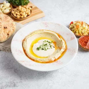 a bowl of hummusle and pita