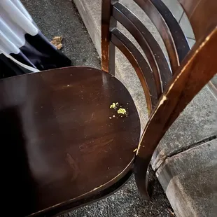 a wooden chair with the seat up