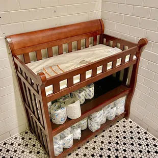 Adorable changing table in the rear restroom for those who are in a family way.