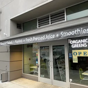 a storefront with a sign on the door