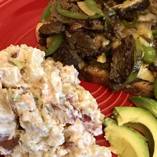 Grilled Steaktan (Seitan) with onions, peppers and plant-based cheese and twice baked potato salad.