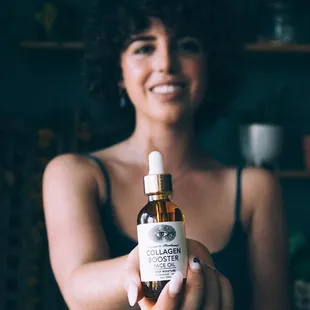 a woman holding a bottle