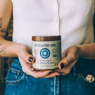 a woman holding a jar