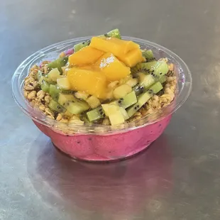 Small Mango Madness. Pitaya (Dragon Fruit) granola, kiwi, mango, pineapple, coconut flakes and honey.