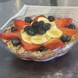Açai Berry. Açai base with granola, banana, strawberry, coconut flakes and honey.