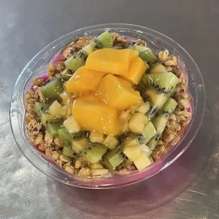 Small Mango Madness. Pitaya (Dragon Fruit) granola, kiwi, mango, pineapple, coconut flakes and honey.