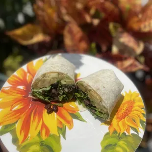 a plate with a burrito cut in half