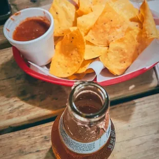 a plate of nachos and a glass of beer