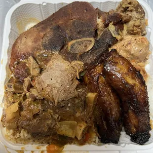 Combination dinner.  Pork chop, stew and chicken with plantains