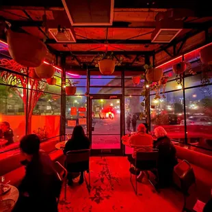 people sitting at tables in a brightly lit restaurant