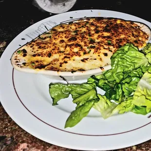 a plate of food and a glass of water