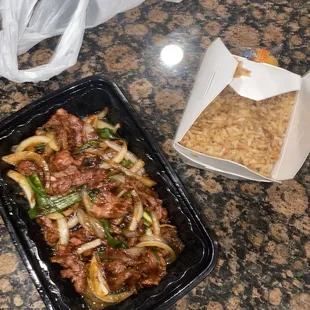 a tray of food and a container of rice