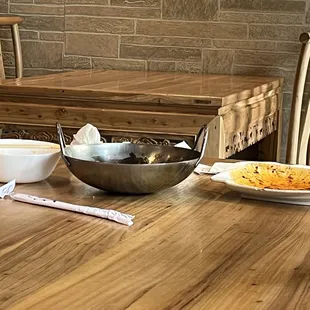 a table with a bowl of food and a bowl of soup
