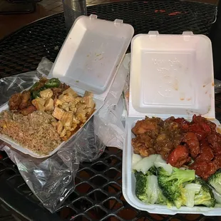 three takeout containers of food on a table