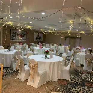 a banquet room decorated with white linens and white tablecloths