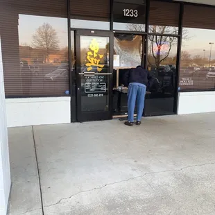 a woman standing in front of a store