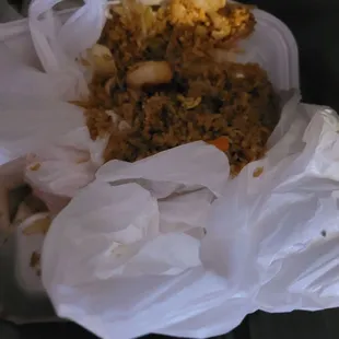 Food that was swept off of the floor after spilling out of the melted styrofoam box