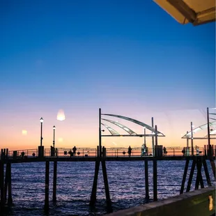 a view of a pier at sunset