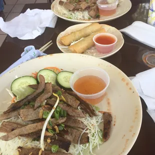 Vietnamese beef rice noodle plates.  Spring rolls in the middle.  Tasty.