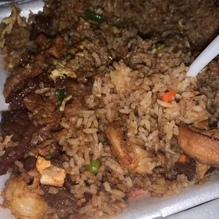 a plate of rice, meat, and vegetables