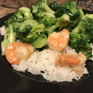 shrimp, broccoli, and rice on a black plate