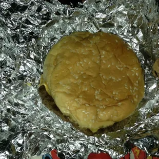 a hamburger wrapped in aluminum foil