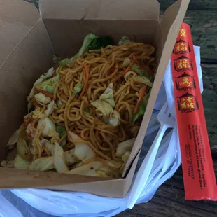 a box of noodles and chopsticks