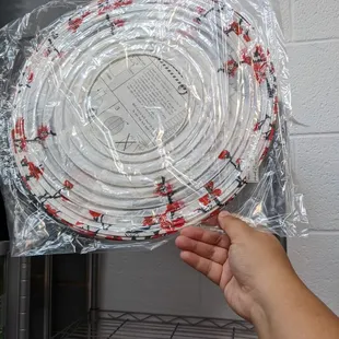 a person holding up a plastic hose