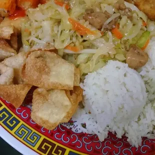 A #34 ( sweet and sour chicken, chicken chow mein, fried wontons, egg roll) served with steamed rice