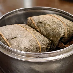 Lo mai gai. Sticky chicken rice in lotus leaf. Dim sum pricing as of August 2021: Small dish $4.09, medium dish $4.99, large dish $5.99.