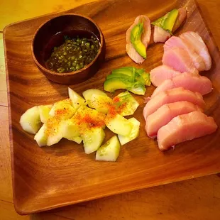 a cutting board with sliced meat and vegetables