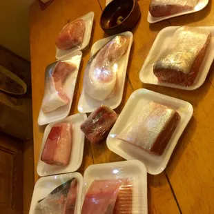 a variety of raw fish in plastic containers