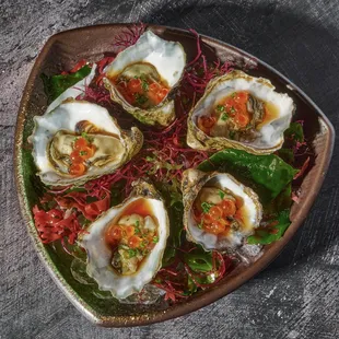 Fresh Kumamoto oysters in Leche De Tigre, ponzu, ikura, shallots &amp; chive.