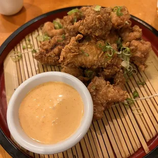 a plate of fried chicken with dipping sauce