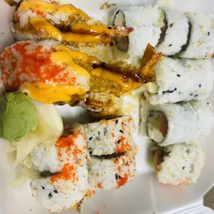 a variety of sushi in a styrofoam container