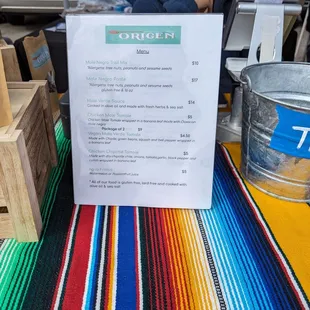 a woman sitting at a table with a menu