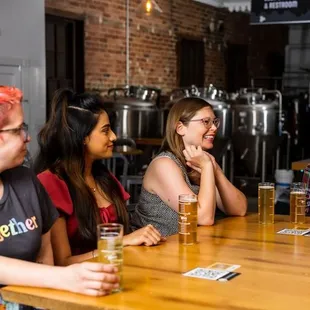 a group of women sitting at a bar