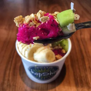 a spoon full of ice cream and fruit