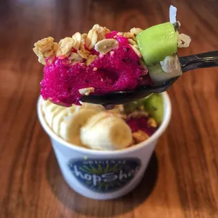 a spoon full of ice cream and fruit