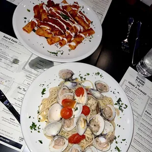 two plates of pasta and clams