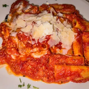 a plate of pasta with sauce and parmesan cheese