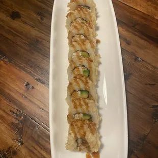 a sushi roll on a white plate