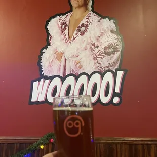 a man in a costume holding a pint of beer