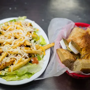 a plate of french fries and a salad