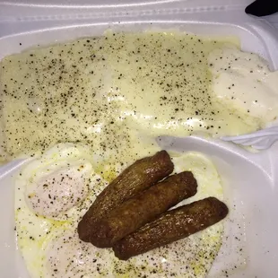 Over easy eggs sausage and grits with cheese