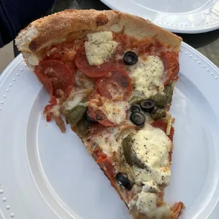 Supreme pizza with no mushrooms and ricotta added.