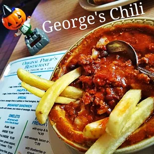 a bowl of chili and french fries