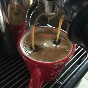 coffee being poured into a cup