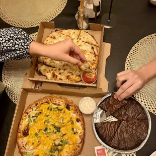 two pizzas and a chocolate cake